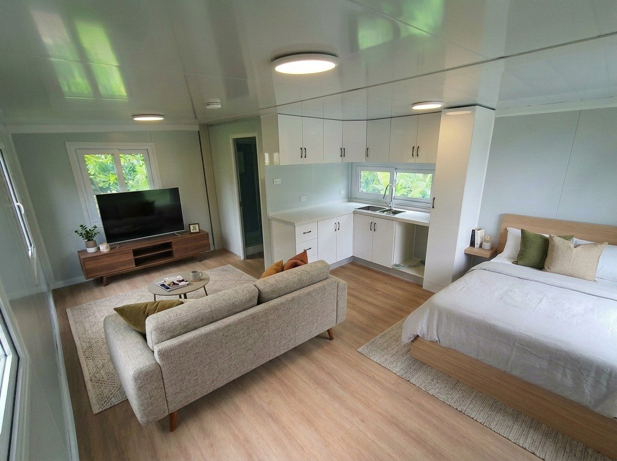 Furnished living area with bed and kitchen