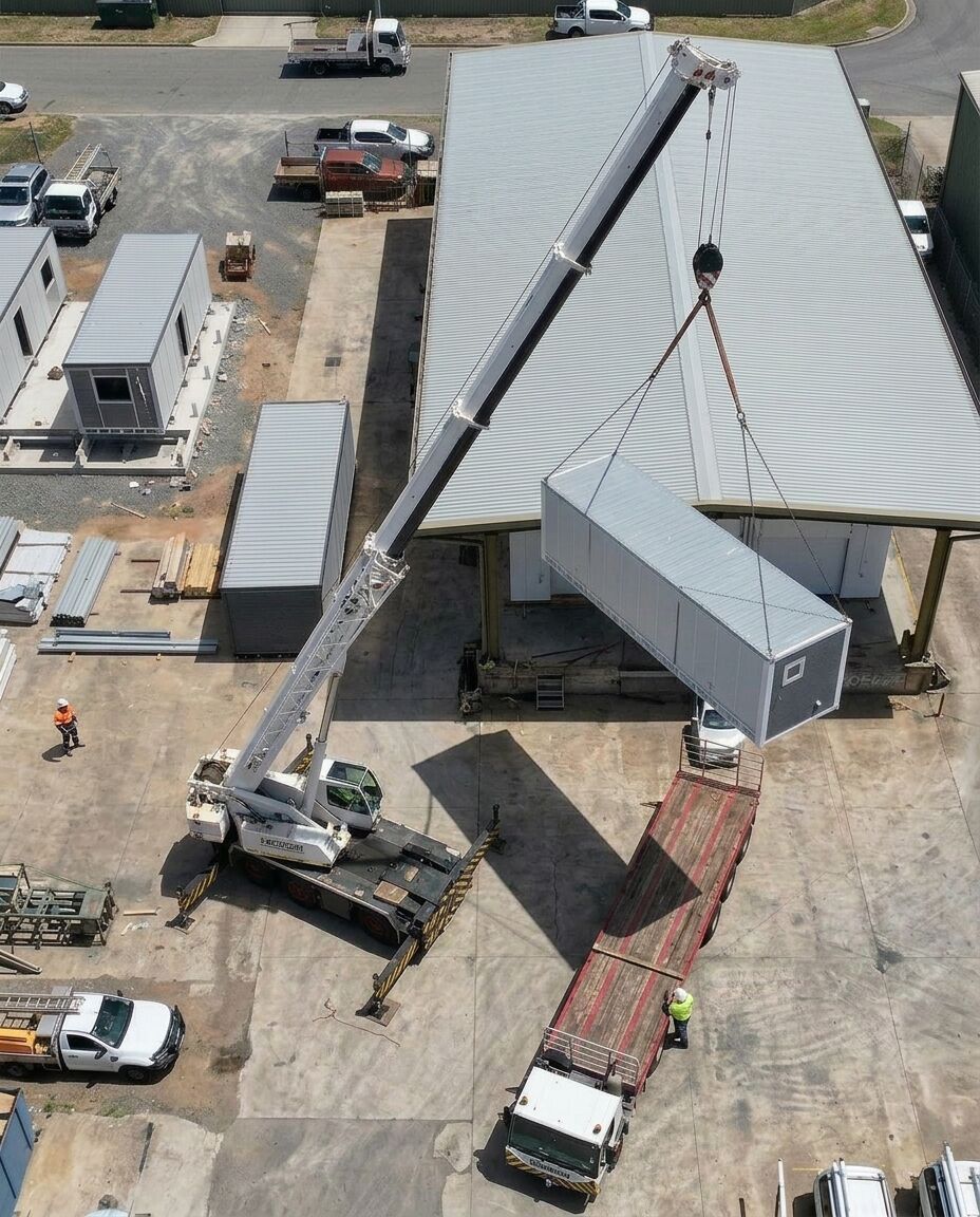 Crane lifting a SmartShift cabin onto a flatbed truck