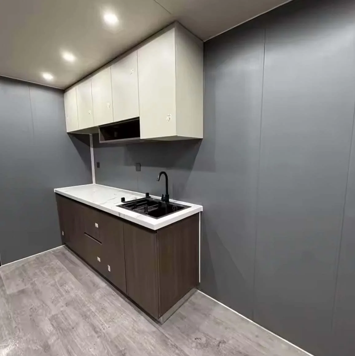 Stella kitchen — walnut, stone and matte-black detail