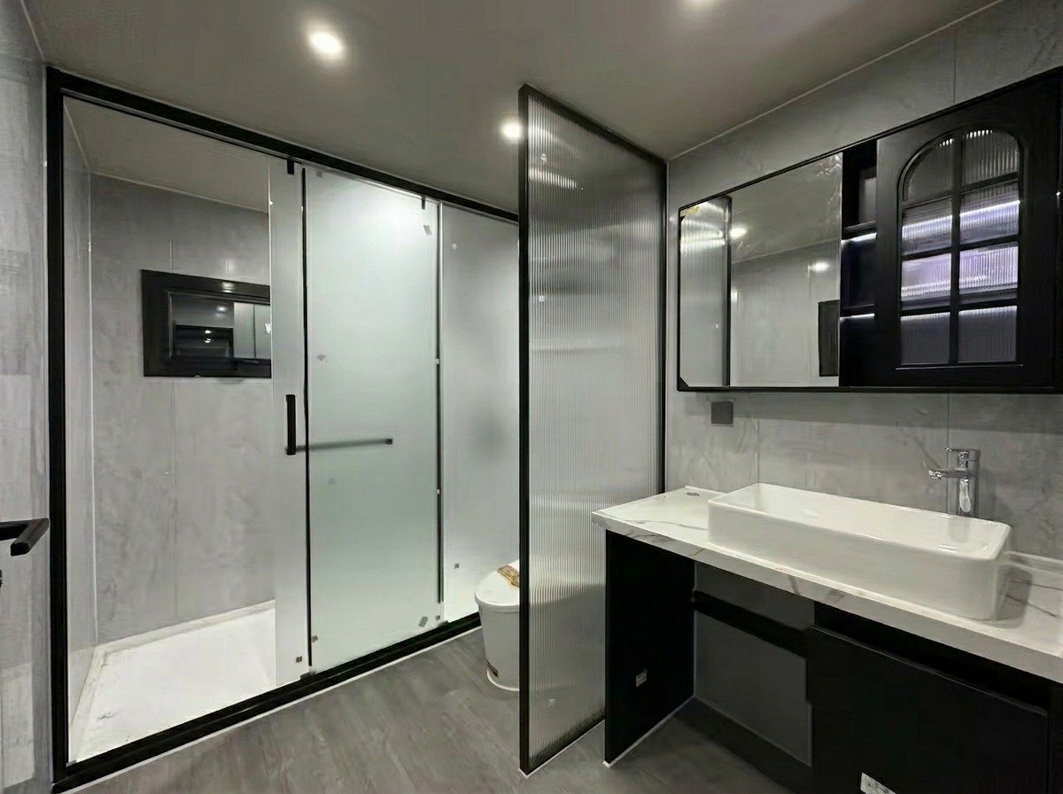Stella bathing suite — shower, vanity and fluted-glass partition