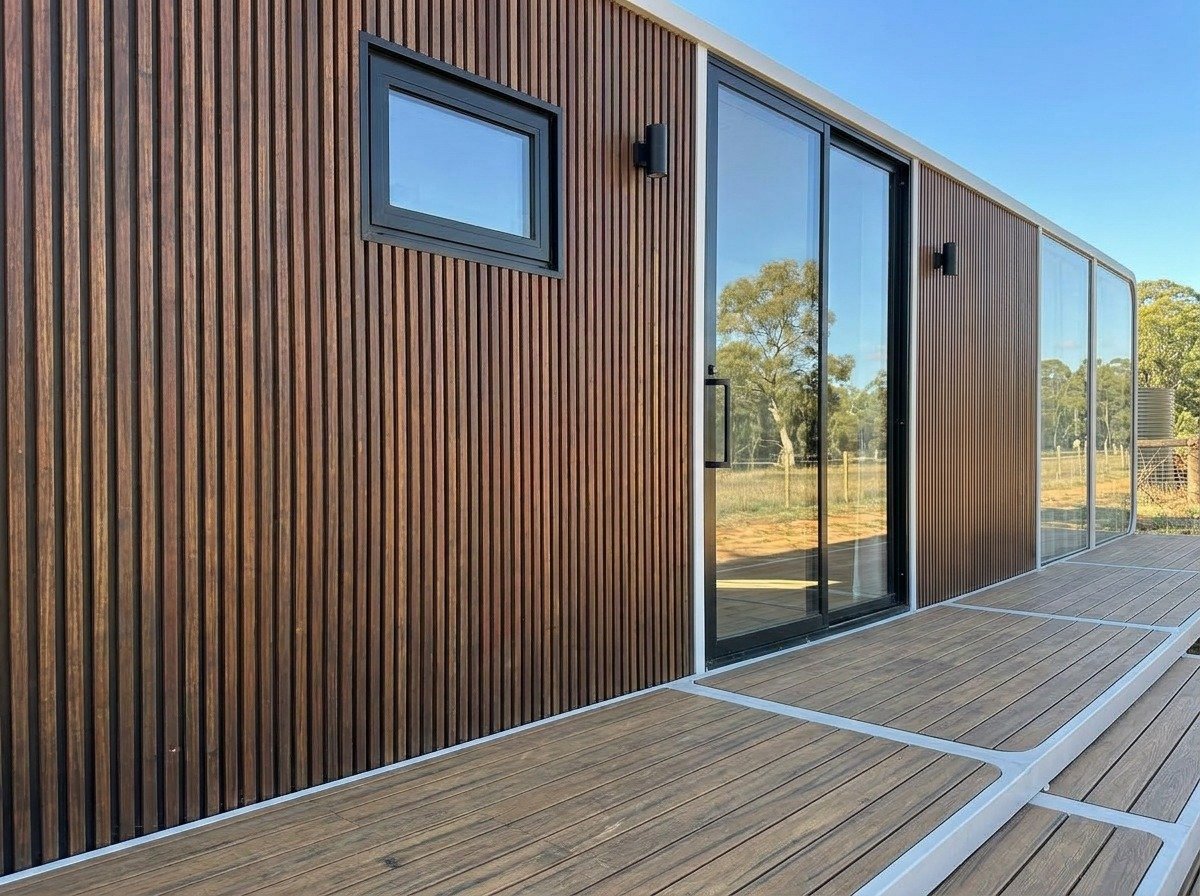 Cladding detail — timber batten meets sculpted white shell